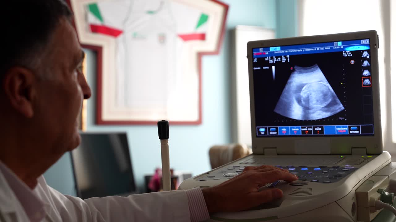 Gynecologist checking baby sonogram scanner. Rack focus