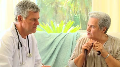 mature woman patient talking with her doctor