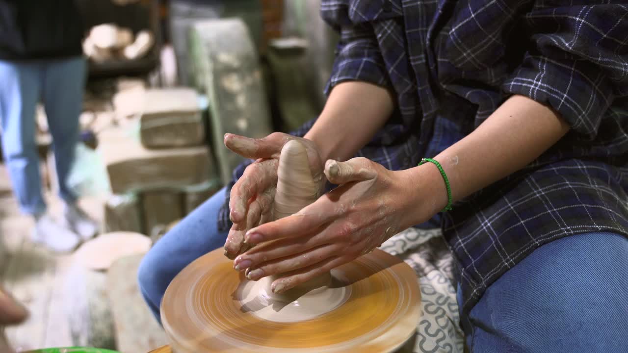 Woman Shaping Clay on a Potters Wheel