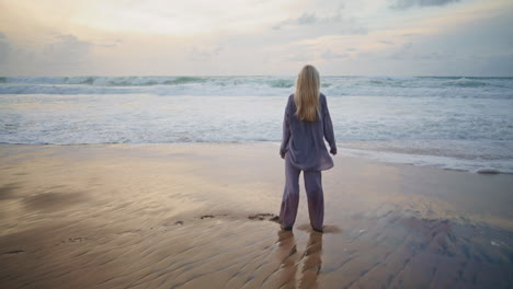 carefree girl spinning ocean coast in summer. romantic woman admiring sunset