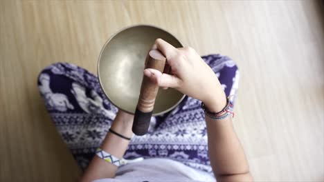 female playing the tibetan bowl