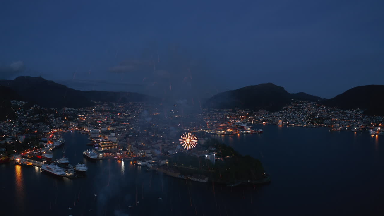 Close-up aerial shot of fireworks over Bergen, Norway on the constitution day May 17
