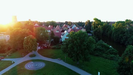 drone flies over the park green meadows small rivers the city ion the horizon aerial view