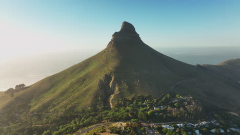 Vegetation-overgrown-steep-slopes-and-rocky-top-of-Lions-Head-mountain.-Open-ocean-in-background.-Cape-Town,-South-Africa