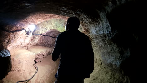 a person exploring a dark cave or tunnel