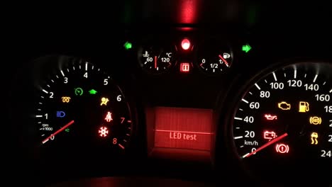 flickering and flashing warning led light on a dashboard panel on car which broke down at night