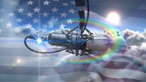 Animation-of-rainbow-lens-flare-and-microphone-over-waving-us-flag-against-clouds-in-the-sky