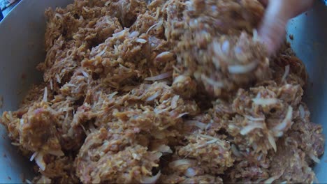 Close-Up-View-Of-Mince-Meat,-Onions-And-Spices-In-Casserole-Pan-Being-Kneaded