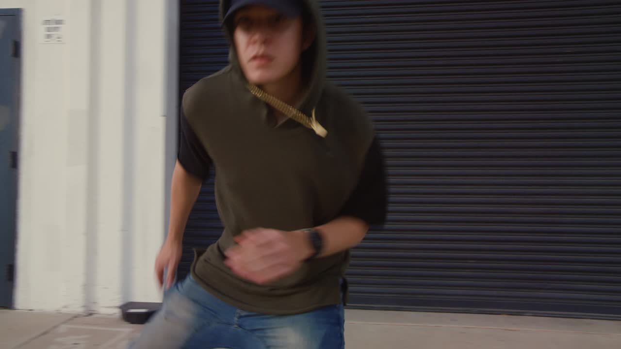 hombre de freestyle hip hop bailando por la acera de la ciudad