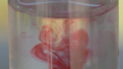 Super-close-up-macro-of-a-test-tube-with-a-water-sample-then-adding-pink-or-red-drops-to-test-for-the-PH-level-which-results-in-a-chemical-reaction