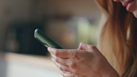 closeup smiling woman browsing smartphone application at home. girl messaging