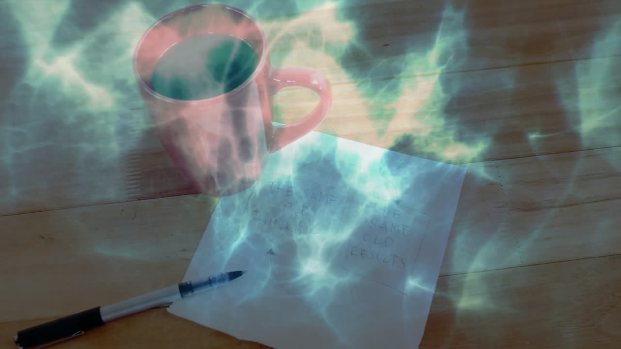 Red ceramic mug glowing in mystical greenish-blue light, sitting on wooden tabletop with notes, pen