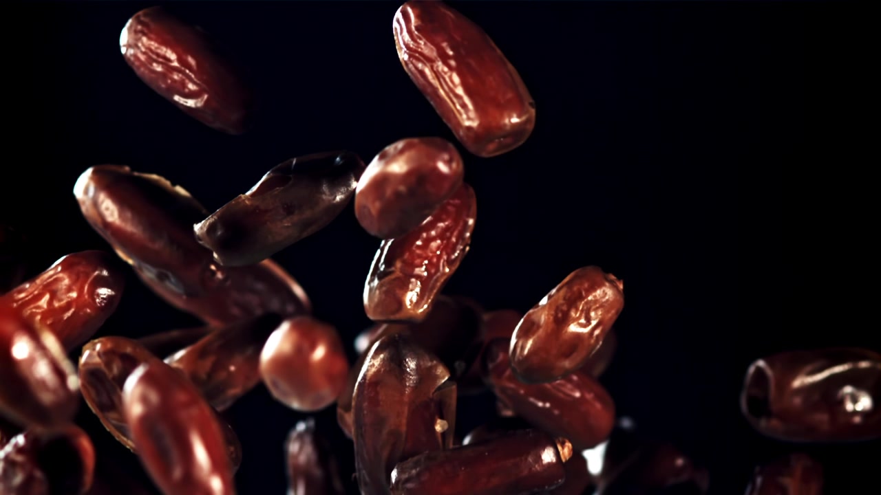 Dates Falling in Slow Motion on Black Background