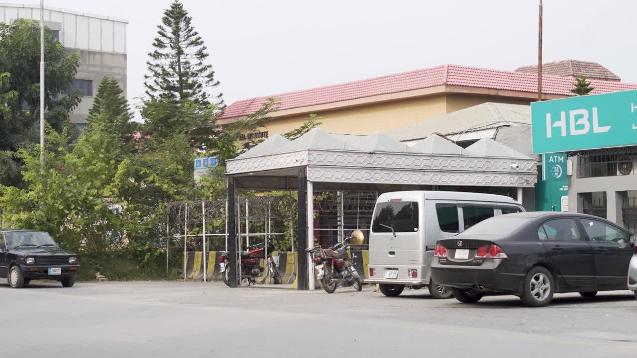 A view of the bank entrance, located on a road bustling with traffic.
