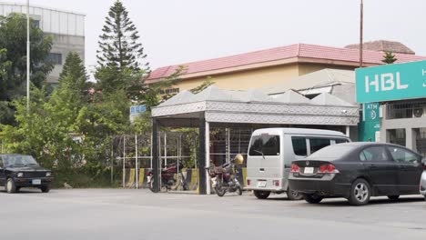 a view of the bank entrance, located on a road bustling with traffic.