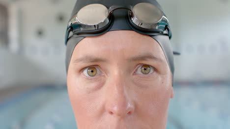 caucasian female swimmer athlete wearing swimming goggles