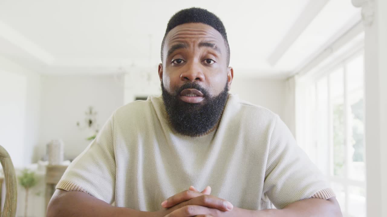 Happy african american man having video call, in slow motion