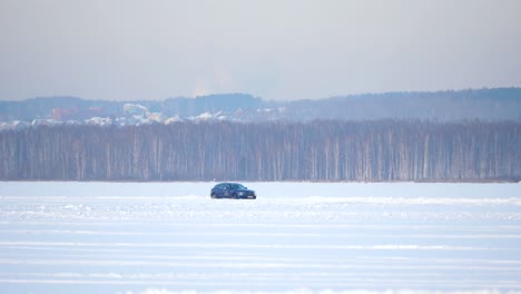 car driving on frozen lake in winter landscape