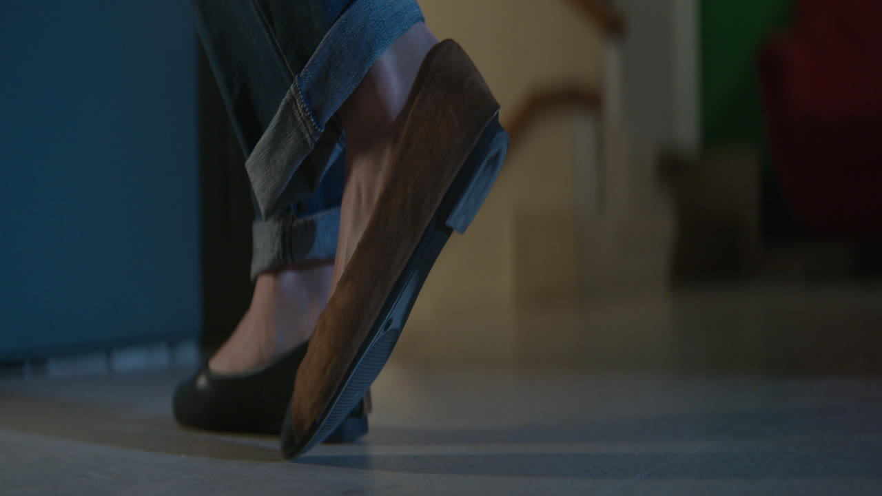 Woman's feet in jeans and shoes