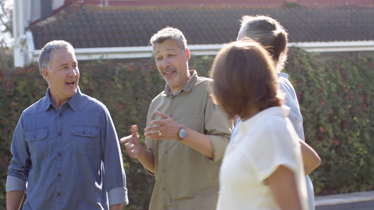 Walking and talking outdoors, senior friends enjoying time together