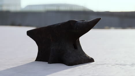 old anvil on a sandy beach