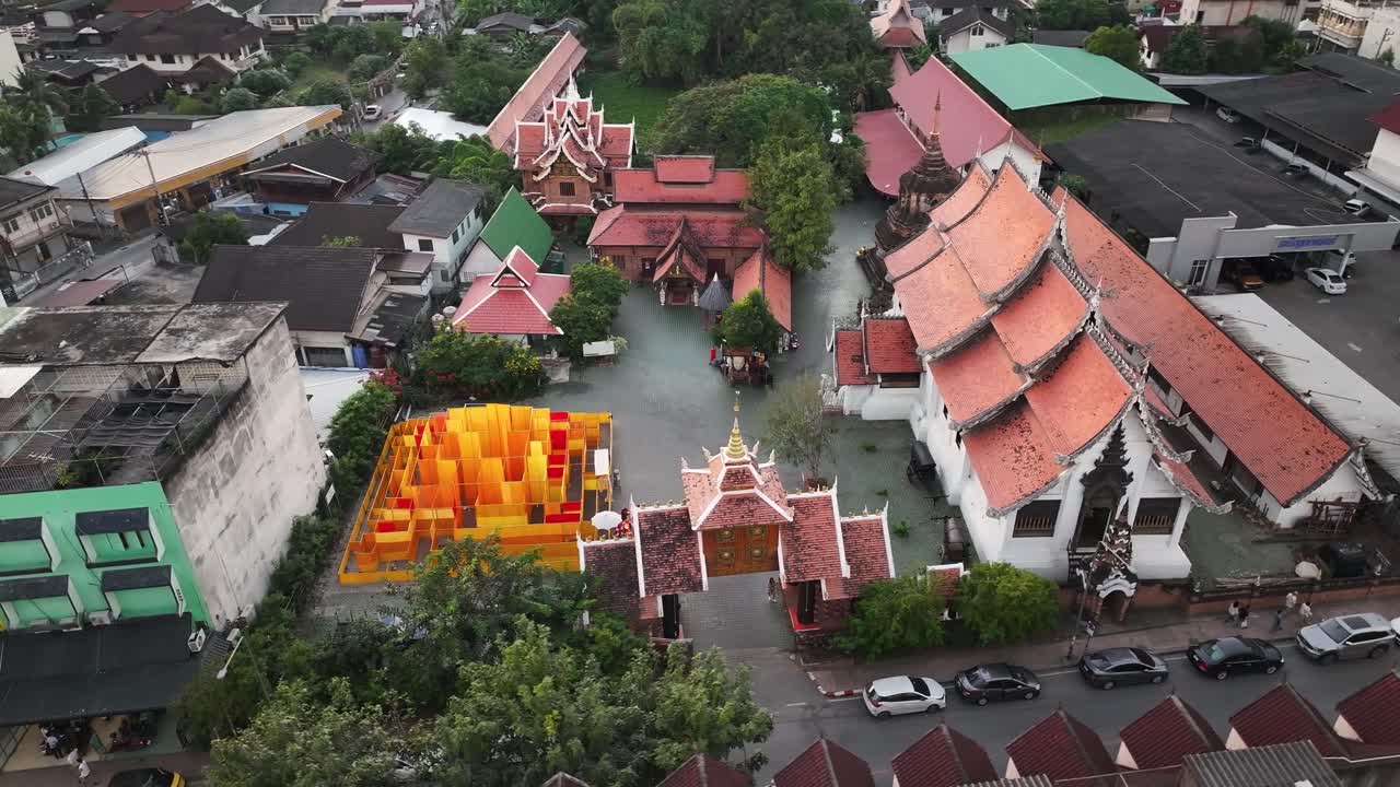 Buddhist Temple with traditional buildings in Chiang Mai old town, Thailand. Drone cityscape.