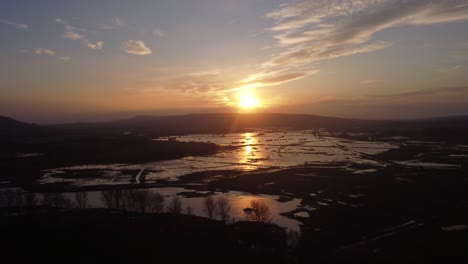 flood plains reflecting rising sun, ariel view