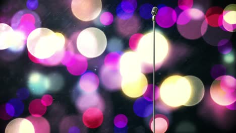 retro metallic microphone against purple spots of light against black background