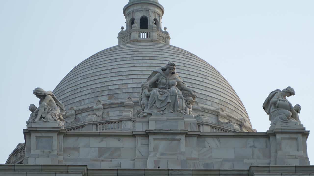 Close-up of the Victoria Memorial dome with elaborate marble sculptures