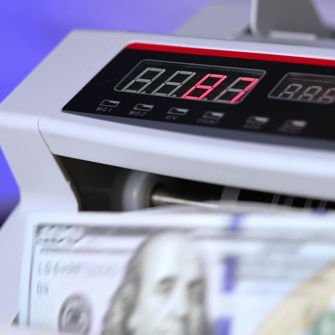 Electronic cash money counter. Counter machine is processing american money banknotes. Mechanism for bank financial operations. Finance concept. Close-up