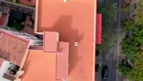 90 degree angled down aerial showing traffic and apartments in the suburbs of spain