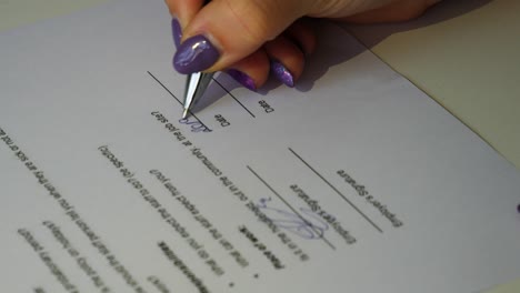 women signing a job contract with a signature and date stamp