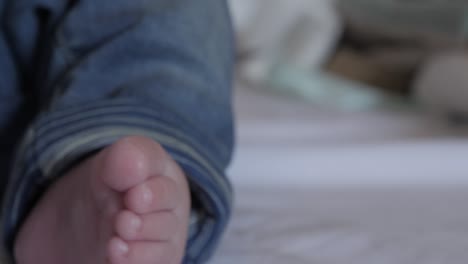 close-up of baby feet as he wiggles his legs and toes