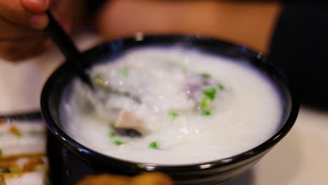 savoring a bowl of delicious pork porridge