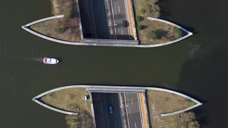 aerial top down veluwemeer aqueduct view from above, boat sailing across aquaduct over traffic tunnel highway