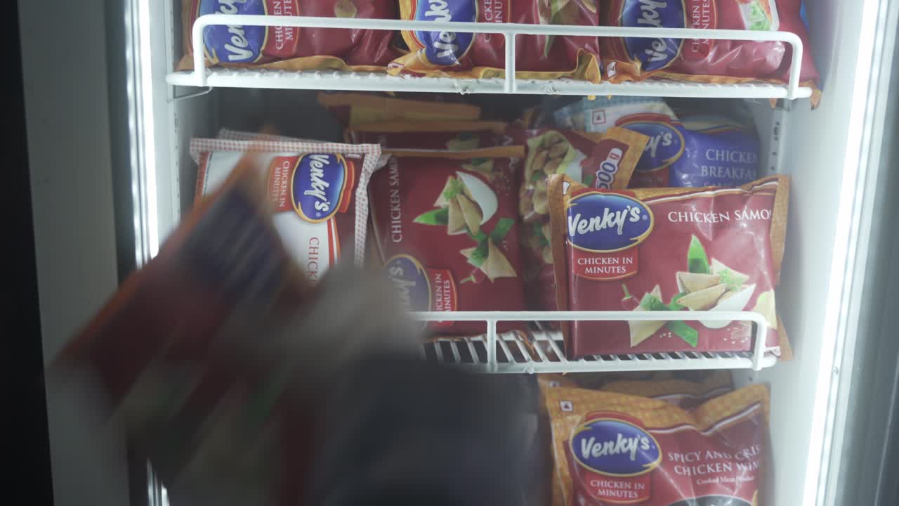 Customer picking frozen packaged and processed food from the refrigerator at a supermarket, Chicken samosa, Indian snacks and food