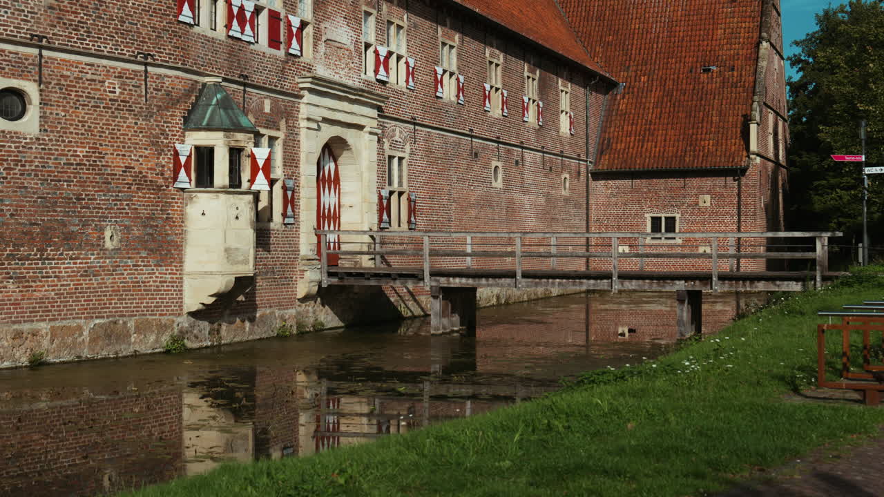 Stone wall and wooden bridge at Schloss Raesfeld, capturing medieval fortress style with nature surrounding the site