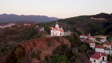 a clip showing footage of the church overlooking karlovasi, which is a town on the island of samos in greece