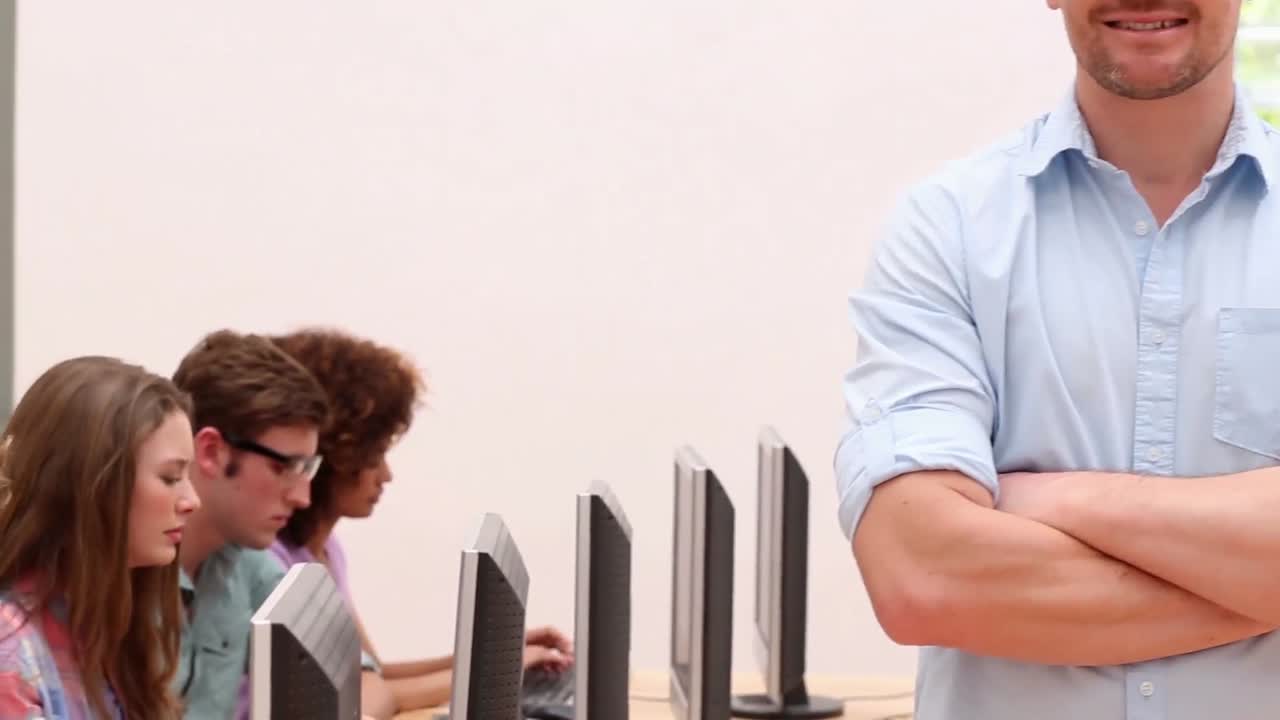 Students working in computer room with lecturer