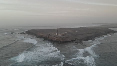 From-a-bird's-eye-view,-behold-the-timeless-charm-of-a-cliffside-lighthouse—an-enduring-symbol-of-coastal-heritage-and-natural-beauty—a-classic-scene-that-evokes-nostalgia-and-wonder