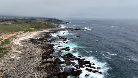 Amazing-cinematic-drone-clip-of-over-the-rocky-terain-and-the-beachhead-and-waves-crushing-over