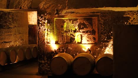 barrels and illuminated art in underground cellar