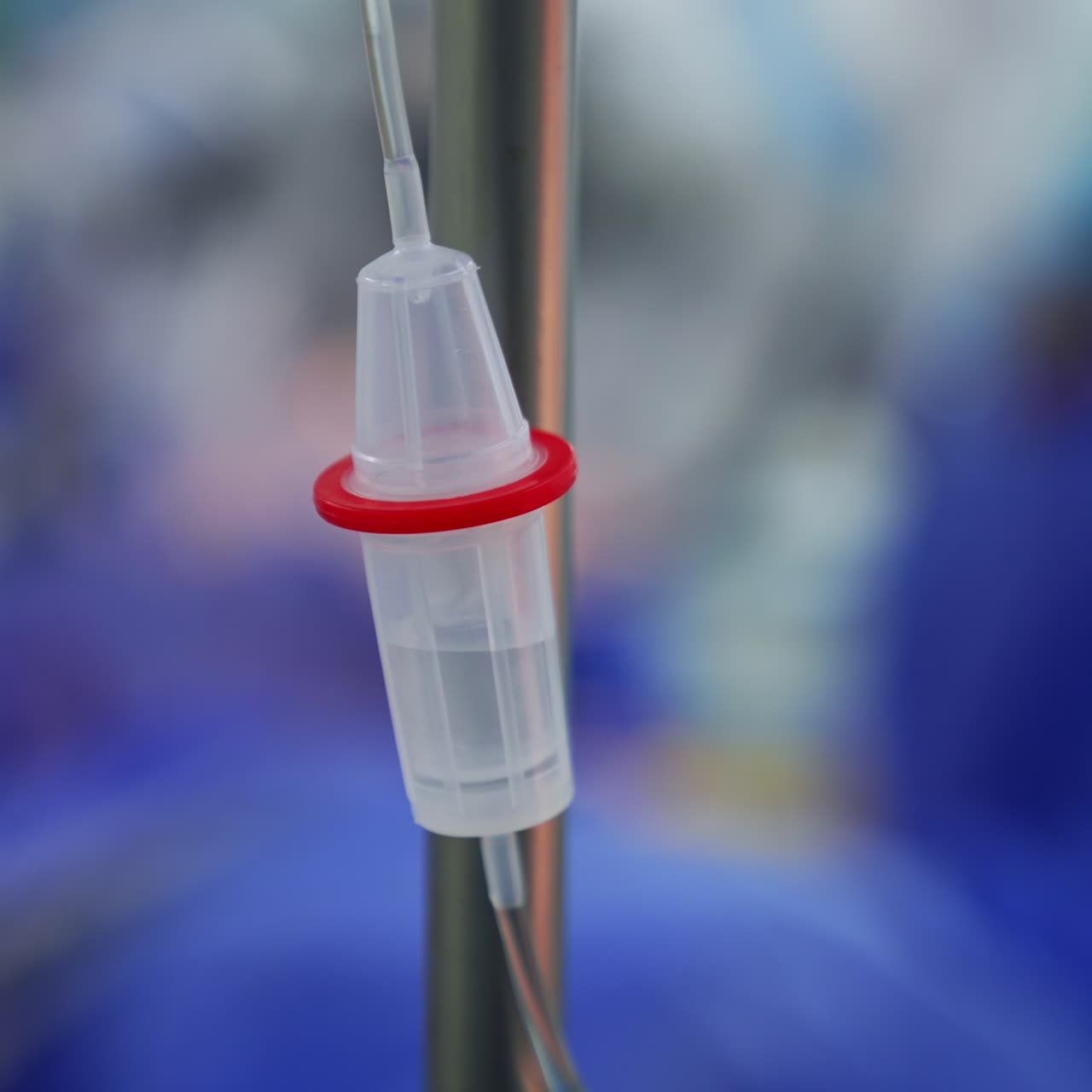 Slowly dripping medicines in the drop counter. Close up. Equipment necessary for modern surgeries. Blurred backdrop