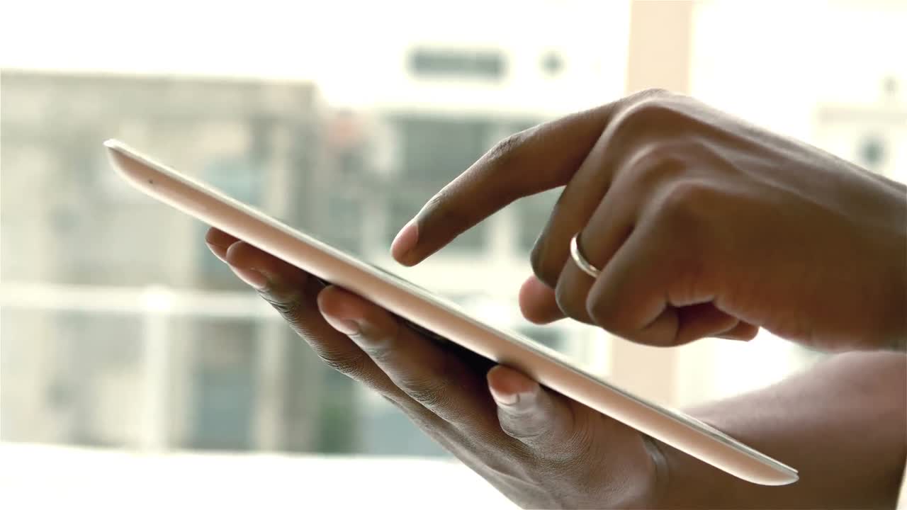 Feminine hands using tablet