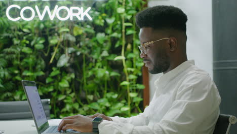 african american businessman working in modern coworking office