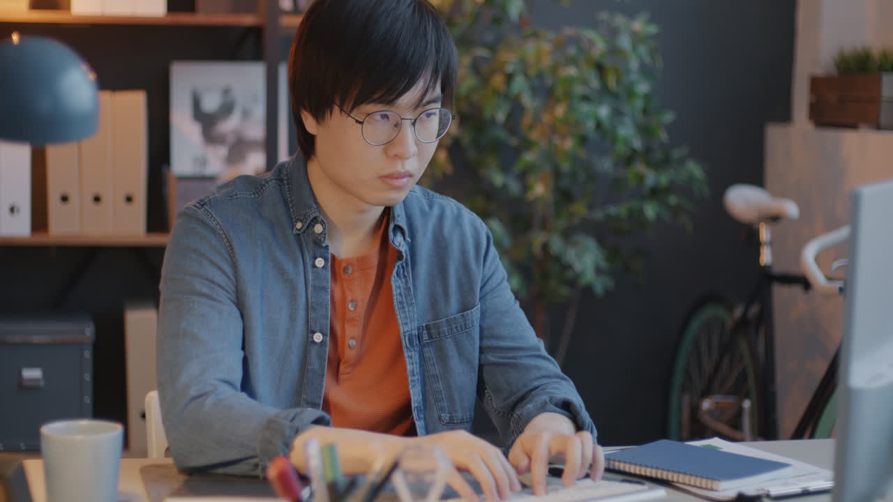 Young man working on computer at home