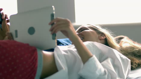 Hübsches-Model-Mit-Tablet-Beim-Liegen-Auf-Dem-Bett