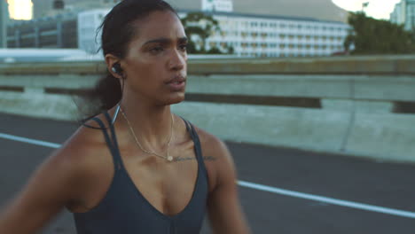 woman running on a city bridge