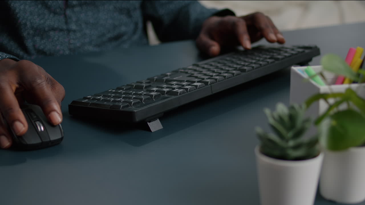 Top view of black man african american hands typing on computer keybord
