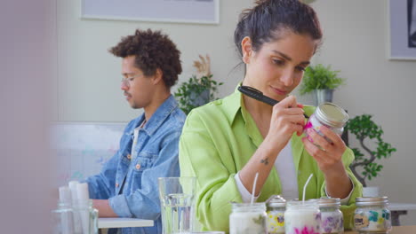 Couple-Running-Online-Business-From-Home-Labelling-And-Smelling-Boutique-Candles-Before-Shipping